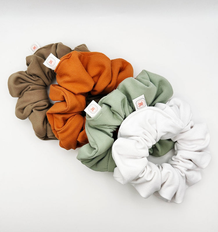  The FitFlex Fusion Performance Set Oversized Scrunchie in various colors - Tan brown, orange Tan, pistachio sage green, and elegant white.